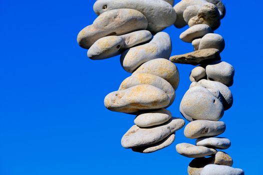 Sea pebbles hanging in the air of a blue sky