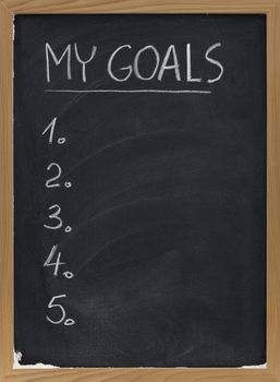 my goals - blank numbered list handwritten with white chalk on blackboard with erase smudges