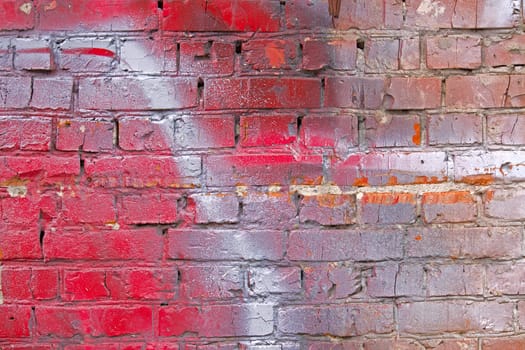 Surface of the wall, lined with red brick and painted