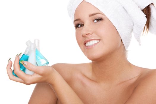 Spa woman holding bottles with shampoo