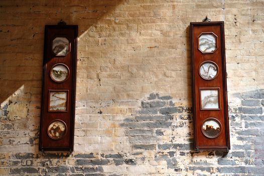 The Chinese artistic panel hanging on brick wall