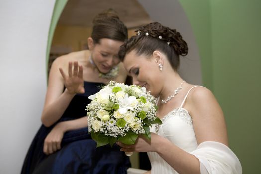 bouquet of bride. Bride with maid of honour talking