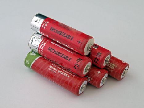 Six used size  AA red rechargeable batteries.