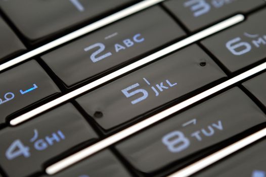 A close up shot of mobile keypad under light