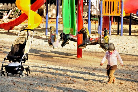 Kid and a pram on the playground
