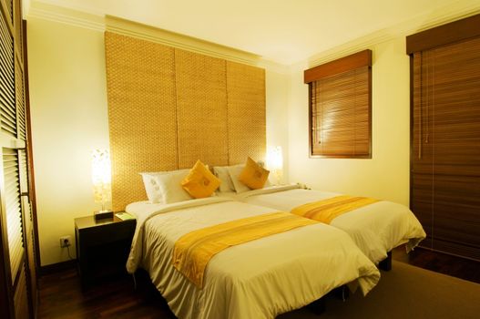 Photo of bed with a table lamp