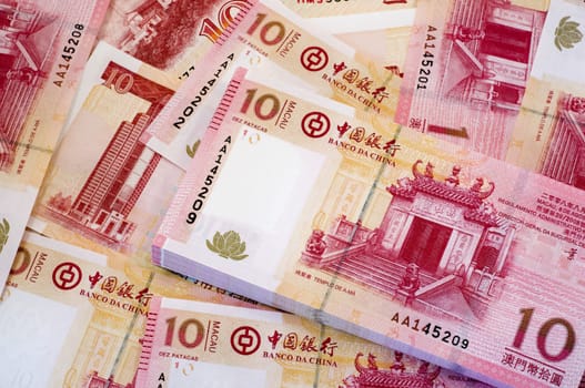 The stack of Macau Patacas as background