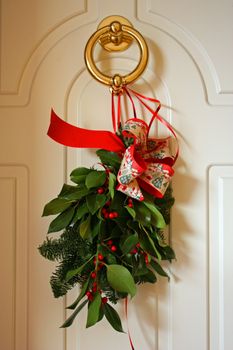 A Christmas decoration on a white door