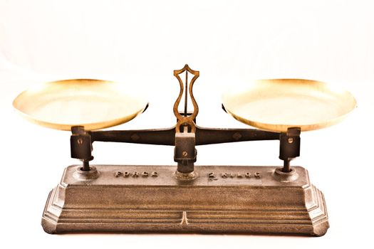 An antique scale on white background, useful for conceptual