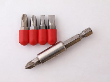 Magnetic screw  driver heads and a holding tool