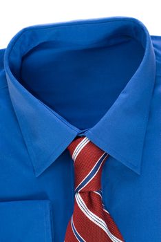 Closeup view of a blue dress shirt and a red tie isolated against a white background