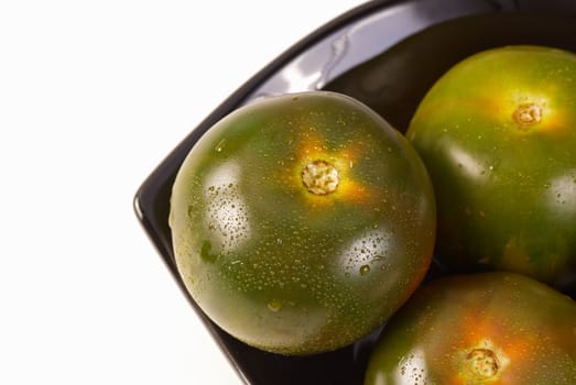 Freshly picked green tomatoes in a bowl