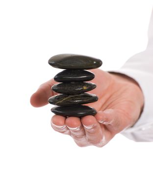 A stack of meditation river rocks being held carefully by a meditating person, isolated against a white background