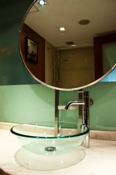 Detail of hotel forniture - elegant sink made of glass