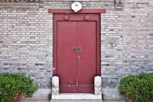 Red door in hutong area, close to Forbidden City, Beijing, China