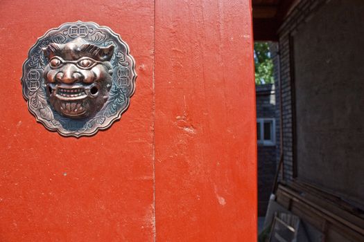 Red door in hutong area, close to Forbidden City, Beijing, China