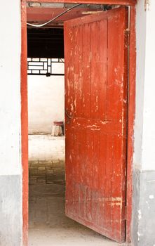 Red door in hutong area, close to Forbidden City, Beijing, China