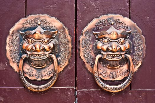 Red door in hutong area, close to Forbidden City, Beijing, China