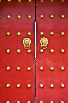 Red door in hutong area, close to Forbidden City, Beijing, China