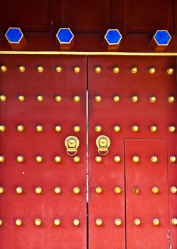 Red door in hutong area, close to Forbidden City, Beijing, China