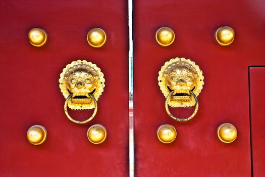 Red door in hutong area, close to Forbidden City, Beijing, China
