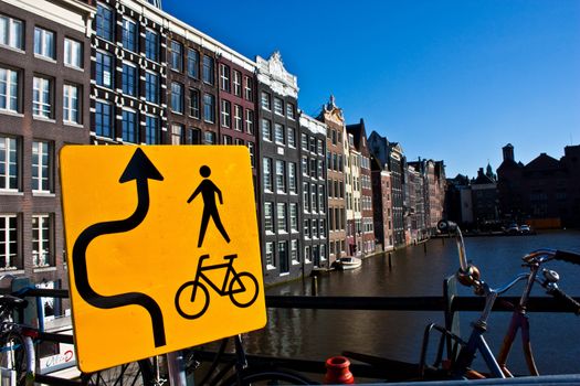 Amsterdam canal view with sign for bicycle, close to the center of the city