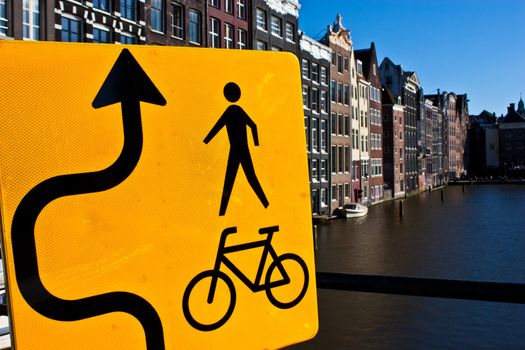 Amsterdam canal view with sign for bicycle, close to the center of the city