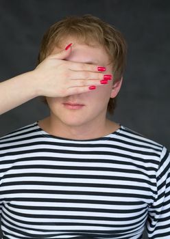 Male portrait with closed eye for female palm