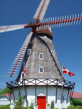 A Windmill stands under a clear blue sky.