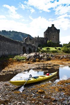 Kayak in front of Eilean Donan Castle, Scotland