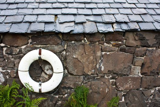Life-preserver on a wall in a fishermen village - Scotland