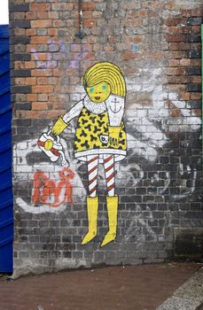 Graffiti Yellow Girl - Brick Lane. London 2008