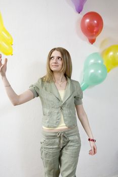 young attractive woman doing exercise with balloon in gym
