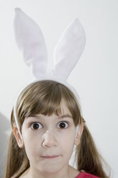 Eyes  beautiful girl in rabbit ears.  Lots of copyspace and room for text on this isolate. Looking in wide-eyed