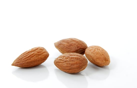 Four pieces of almond on white background