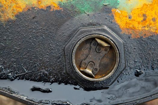 Detail of a rusty, leaking oil barrel