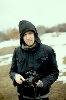 Outdoor photographer portrait in misty weather, washed out colors