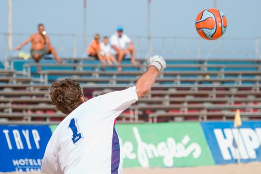 Goalkeeper passing the ball with the hands to a companion