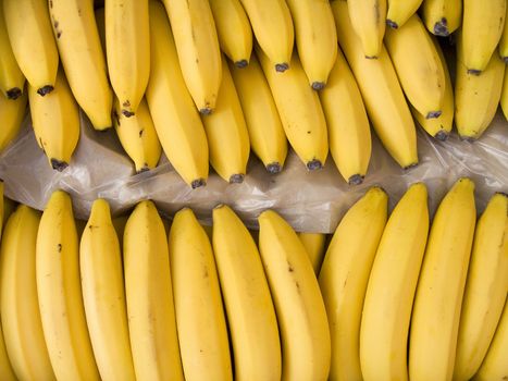 Yellow bananas in a box on sale