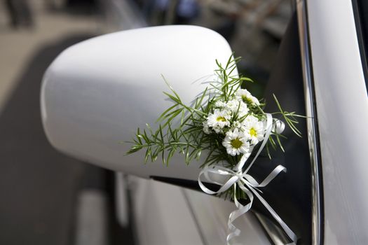  decoration of wedding  limousine. Bouquet of camomile.