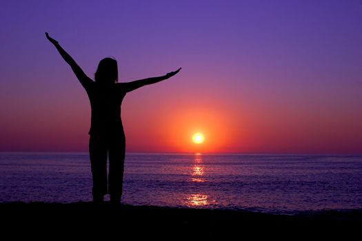 Woman silhouette at the sunset on a beautiful end of the day