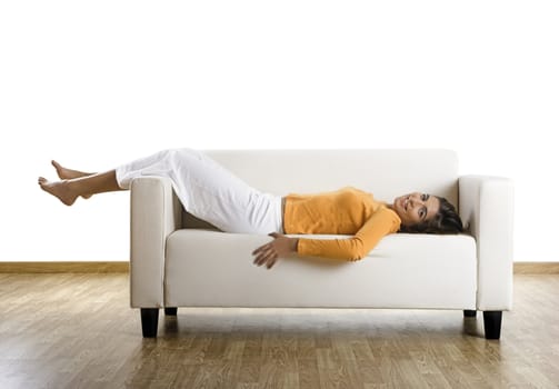 Beautiful woman laughing on the couch at home