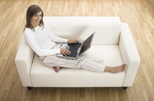 Beautiful woman working at home with her laptop