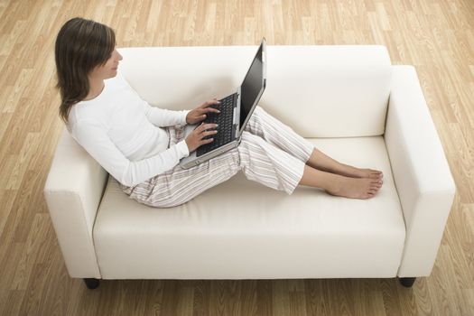 Beautiful woman working at home with her laptop