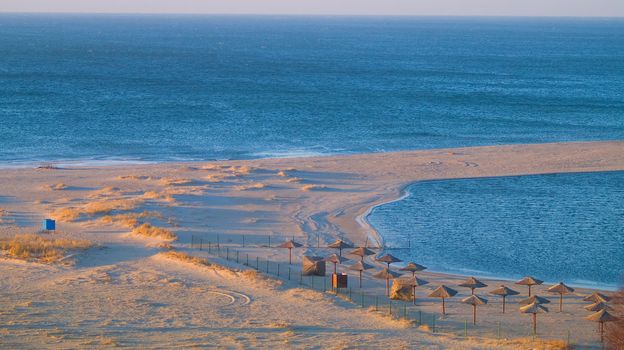 aerial view of desolated seabeach with parasols