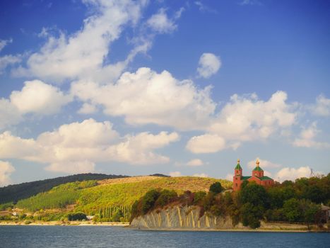 Bright summer landscape with church on a cliff