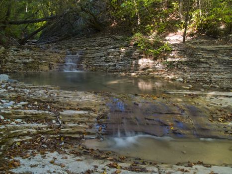 Small water cascade in mountains.