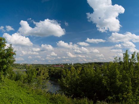 Sunny day at small Russian town, view from hill knap