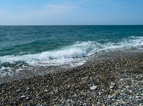 Waves on a pebbles sea beach
