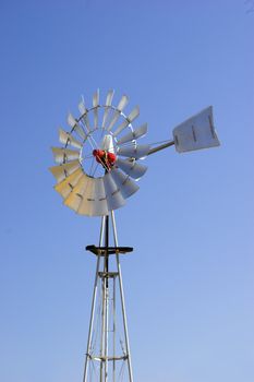 Picture of a farm windmill with a great blue sky in background
